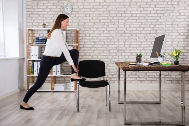 Standing hip flexor stretch beside office desk